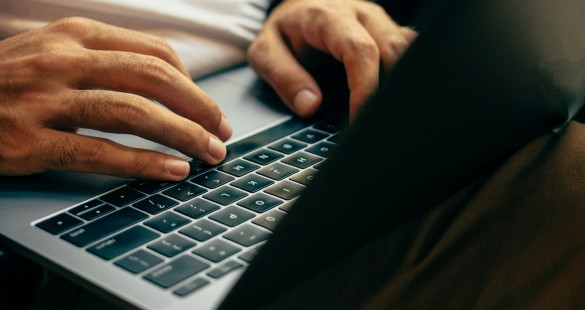 Close-up of a person typing on a laptop keyboard, highlighting focused and productive work.